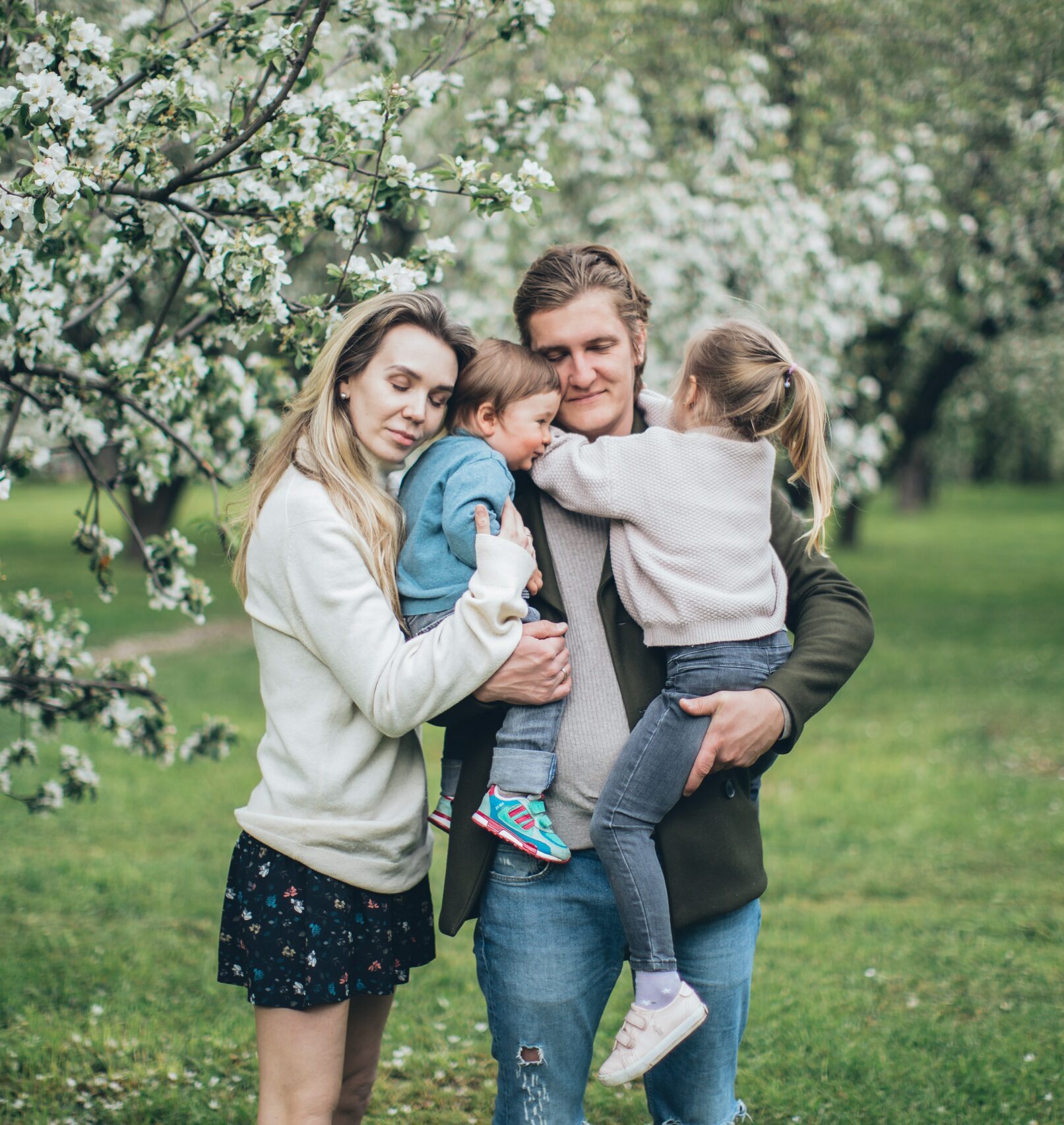an embraced family of four by a tree dealing with the challenges of dysfunctional families
