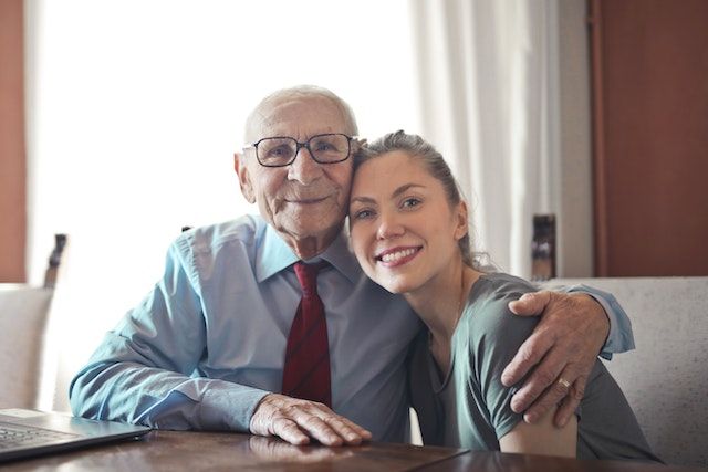 Older adult and his granddaughter.