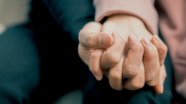 People holding hands as a symbol of support, which is a crucial aspect of overcoming the fear of the unknown
