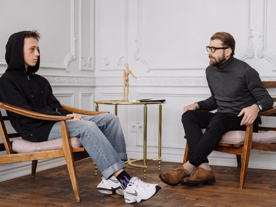 a therapist having a session with a teenager